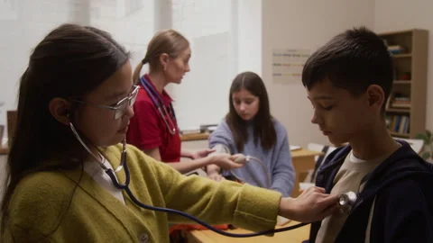 Paramedic Giving Interactive Presentation to Kids in School Stock Footage 328326218