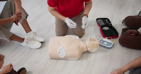 Paramedic, hands and talking with dummy for CPR class, first aid training or Stock Footage 297170443