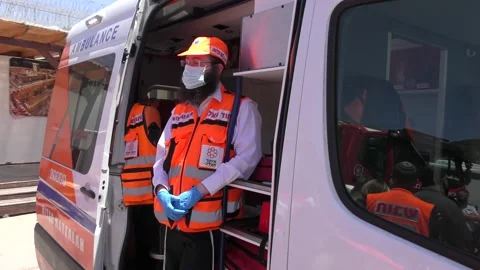 Paramedic of Ihud Hazala getting ready for resuscitating near ambulance Stock Footage 133536725