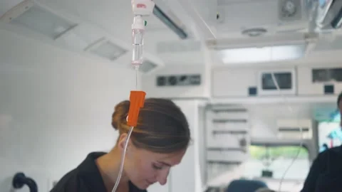 Paramedic looking after the drop injection in an ambulance Video stock 134333540