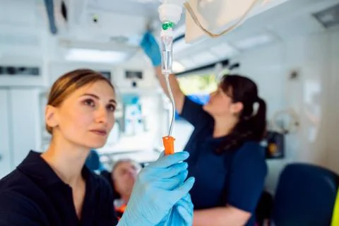 Paramedic looking after the drop injection in an ambulance Foto stock