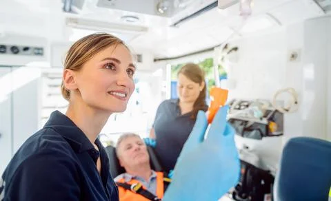 Paramedic looking after the drop injection in an ambulance Stock Photos