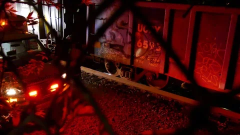 Paramedic looking at dead body under train at night 스톡 동영상 77894995