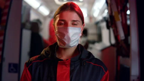 Paramedic in medical mask posing at camera. Woman wearing protective mask Stock Footage 166865736