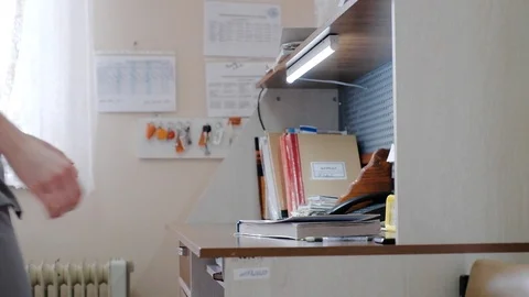 Paramedic nurse on duty at the table doing paper work Video stock 106447187