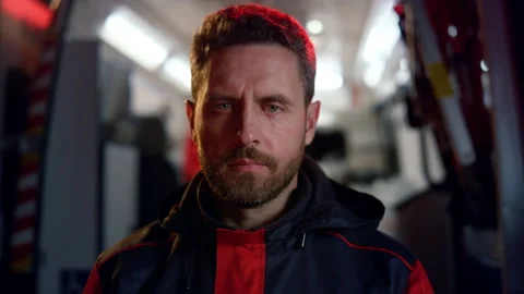 Paramedic posing at camera on street. Medic standing against emergency car 스톡 동영상 166864313