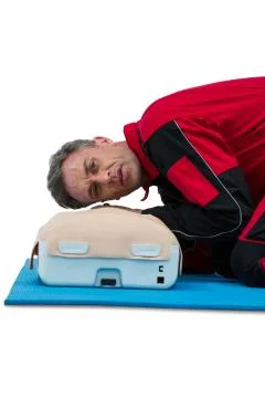 Paramedic practicing resuscitation on dummy 스톡 사진