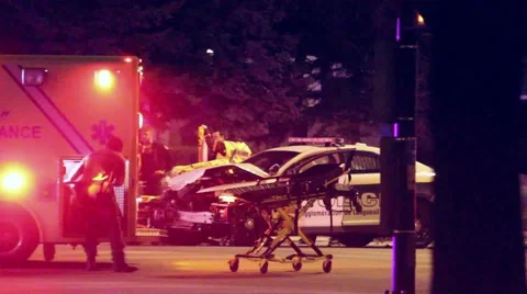 Paramedic pulls stretcher out of ambulance Stock Footage