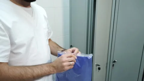  paramedic putting on disposable clothes Stock Footage 130649049