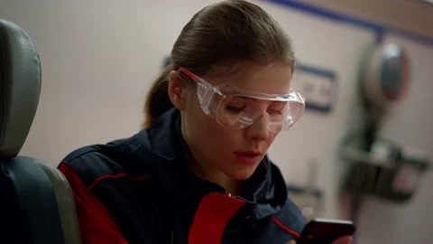 Paramedic reading message on mobile phone. Doctor with cellphone in vehicle Stock Footage 166844514