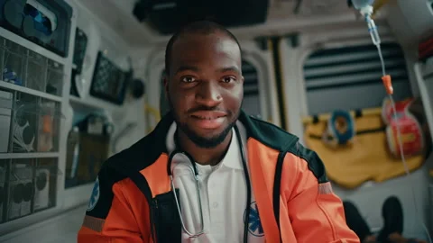 Paramedic Riding in Ambulance Using Tablet with Patient Stock Footage 141570230