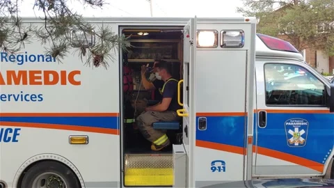 Paramedic service car doors open man drink  take mask off 스톡 동영상 151471995