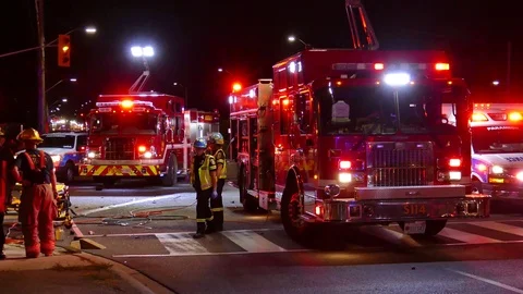 Paramedic Supervisors Stand By At Firetruck While Watching Patient Extrication Video stock 70795417
