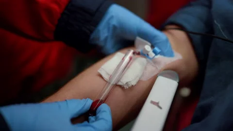 Paramedic taking sample for blood test. Doctor providing medical help to man Stock Footage 166888063