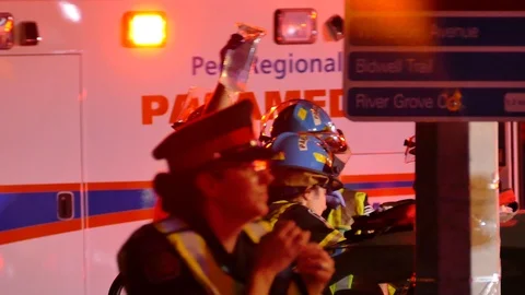 Paramedic Talking While IV Fluid Is Being Applied During Car Crash Extrication - Stock Footage 91565969