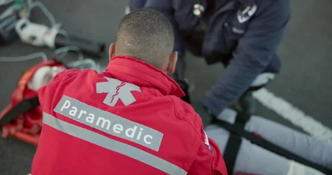 Paramedic, team and man with first aid in emergency, care or helping with injury Stock Footage 252636679