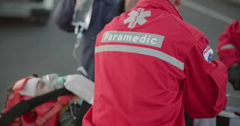 Paramedic, team and man with first aid in emergency, care or helping with injury Stock Footage 252636805