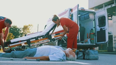 Paramedic team performing first aid preparing the stretcher Stock Footage 211819637