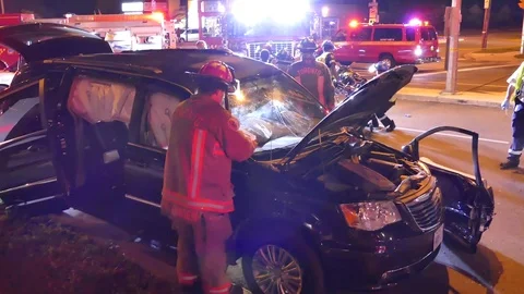 Paramedic unit moving patient from scene to ambulance Stock Footage 77887182