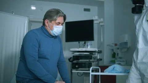 Paramedic is using a special device to measure patient's temperature. COVID 19 스톡 동영상 128196176