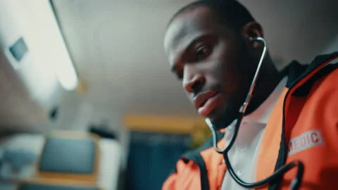 Paramedic Using Stethoscope on Patient in Ambulance Stock-Footage 141569617
