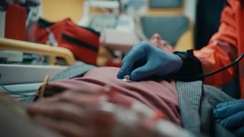 Paramedic Using Stethoscope on Patient in Ambulance 動画素材 141569718