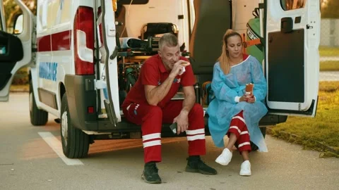Paramedic workers having lunch break together Stock Footage 211821044