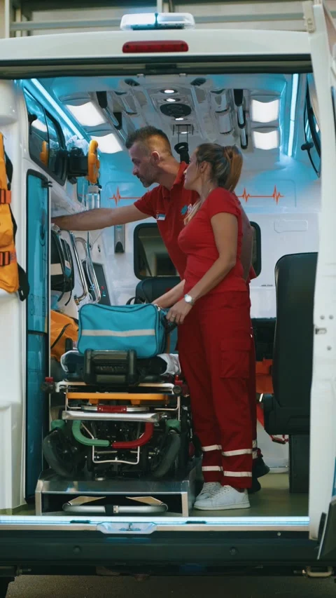 Paramedic workers prepare and check equipment into emergency car Stock Footage 211821753