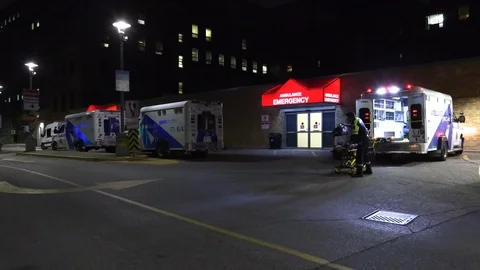 Paramedics ambulances lined up at emergency at trauma hospital Stock Footage 118559448