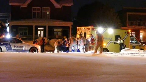 Paramedics and firemen join effort to assist patient and loading him Video stock 88686841