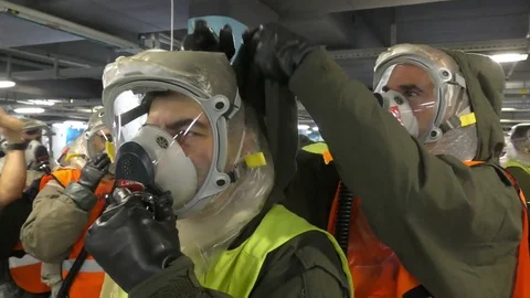 Paramedics and stretcher bearers dressing protective suits Stock Footage 81439232