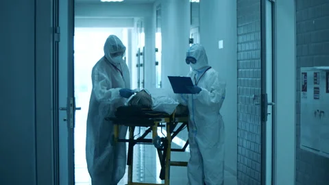Paramedics are checking up a patient in the corridor Video stock 130657070