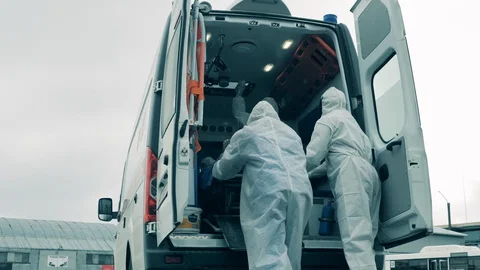 Paramedics are taking a boy on a trolley out of the ambulance Video stock 129490546