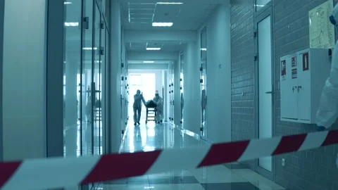 Paramedics are transporting a patient through the hospital during coronavirus Video stock 130657562