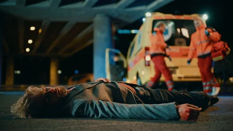 Paramedics Arrive to Help Young Man on a Street Stock Footage 141572466