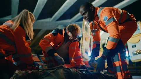 Paramedics Arrive to Help Young Man on a Street 動画素材 141572555