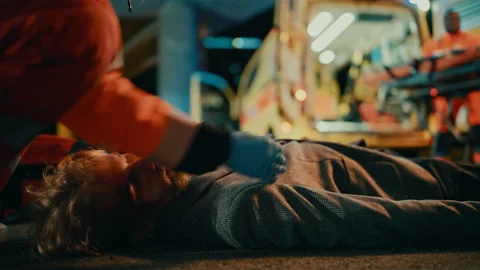 Paramedics Arrive to Help Young Man on a Street Stock Footage 141572607