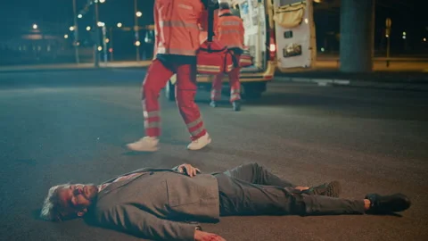 Paramedics Arrive to Help Young Man on a Street Stock Footage 141572692