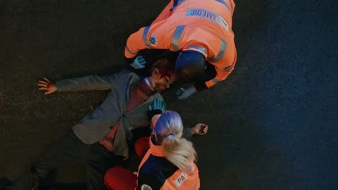 Paramedics Arrive to Help Young Man on a Street Video stock 141574412