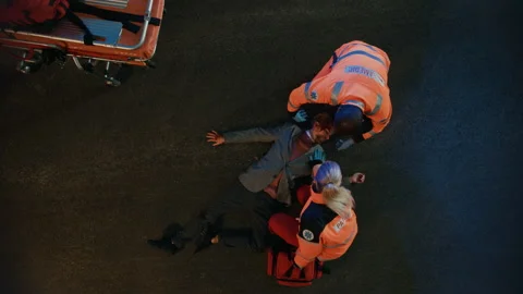 Paramedics Arrive to Help Young Man on a Street Stockbeeldmateriaal 141574416