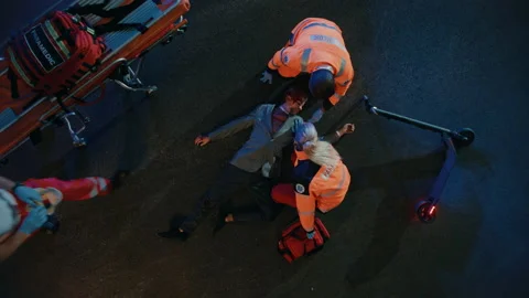Paramedics Arrive to Help Young Man on a Street 動画素材 141574555