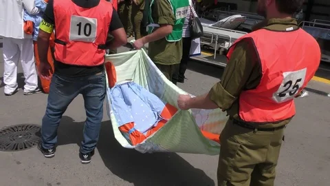 Paramedics bring victims of earthquake on bed sheets, running out of stretchers Stock Footage 75021653