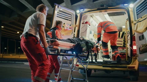 Paramedics Bringing Patient inside Ambulance on Stretcher Stock Footage 141572053