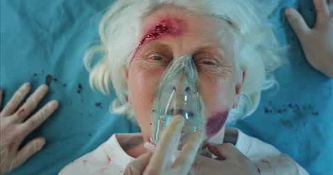 Paramedics checking heart rate and putting on oxygen inhalation mask on old Stock Footage 138820926