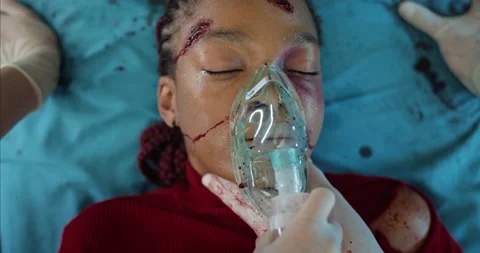 Paramedics checking heart rate and taking off oxygen inhalation mask from young Stock Footage 139530807