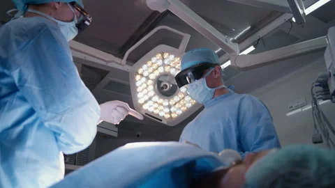 Paramedics discuss process of surgery near table 스톡 동영상 252111345