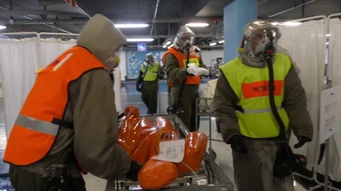 Paramedics dressing protective suits against chemical substances 스톡 동영상 81441335