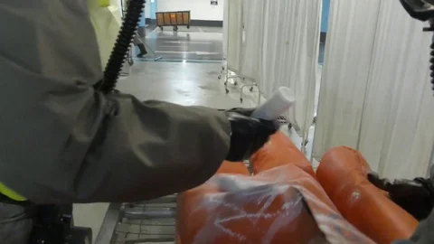 Paramedics dressing protective suits against chemical substances Stockbeeldmateriaal 81442322