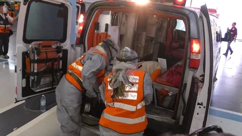 Paramedics dressing protective suits against chemical substances from rocket Stock Footage 81444589