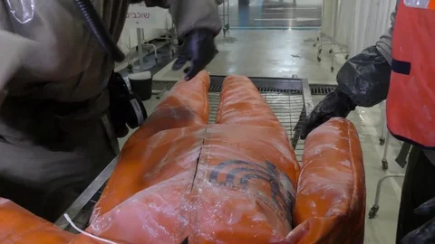 Paramedics dressing protective suits wash chemical attack victim Stock Footage 81442799